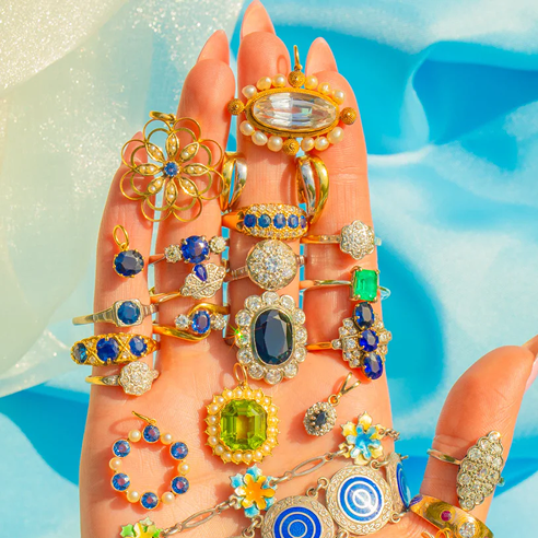 Hand adorned with colourful rings and jewellery, Lillicoco Jewellery